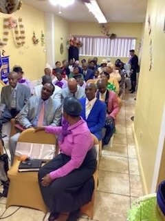 The congregation seated in rows inside the church